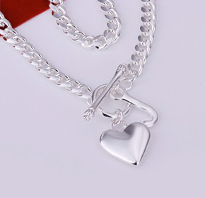 $25.00 for a Silver Heart and Fish Bone Charm Necklace  from Allure Couture Jewelry ($149.00 Value)